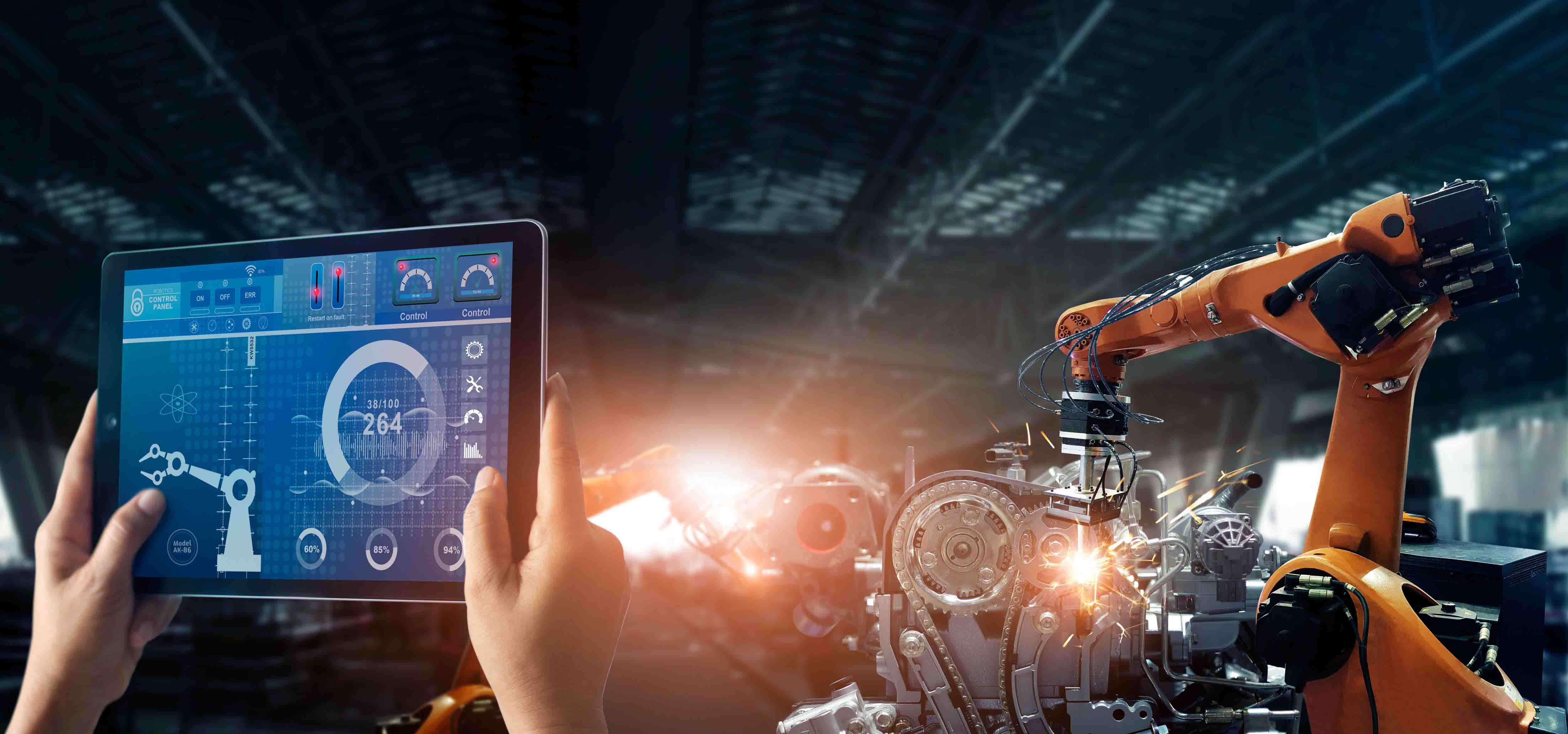 An operator using a tablet alongside manufacturing equipment